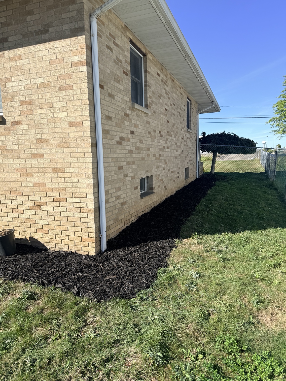 Fresh dark mulch bed cleanup along home exterior Northeast Ohio