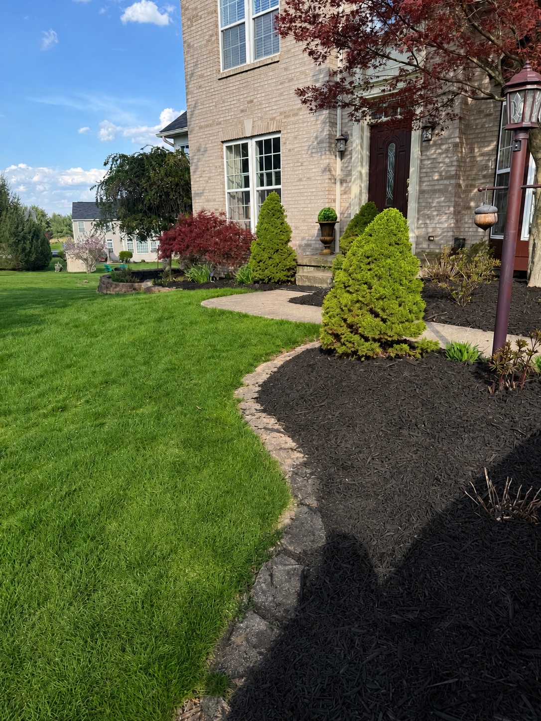 Professionally landscaped home with fresh mulch and manicured lawn Canton OH