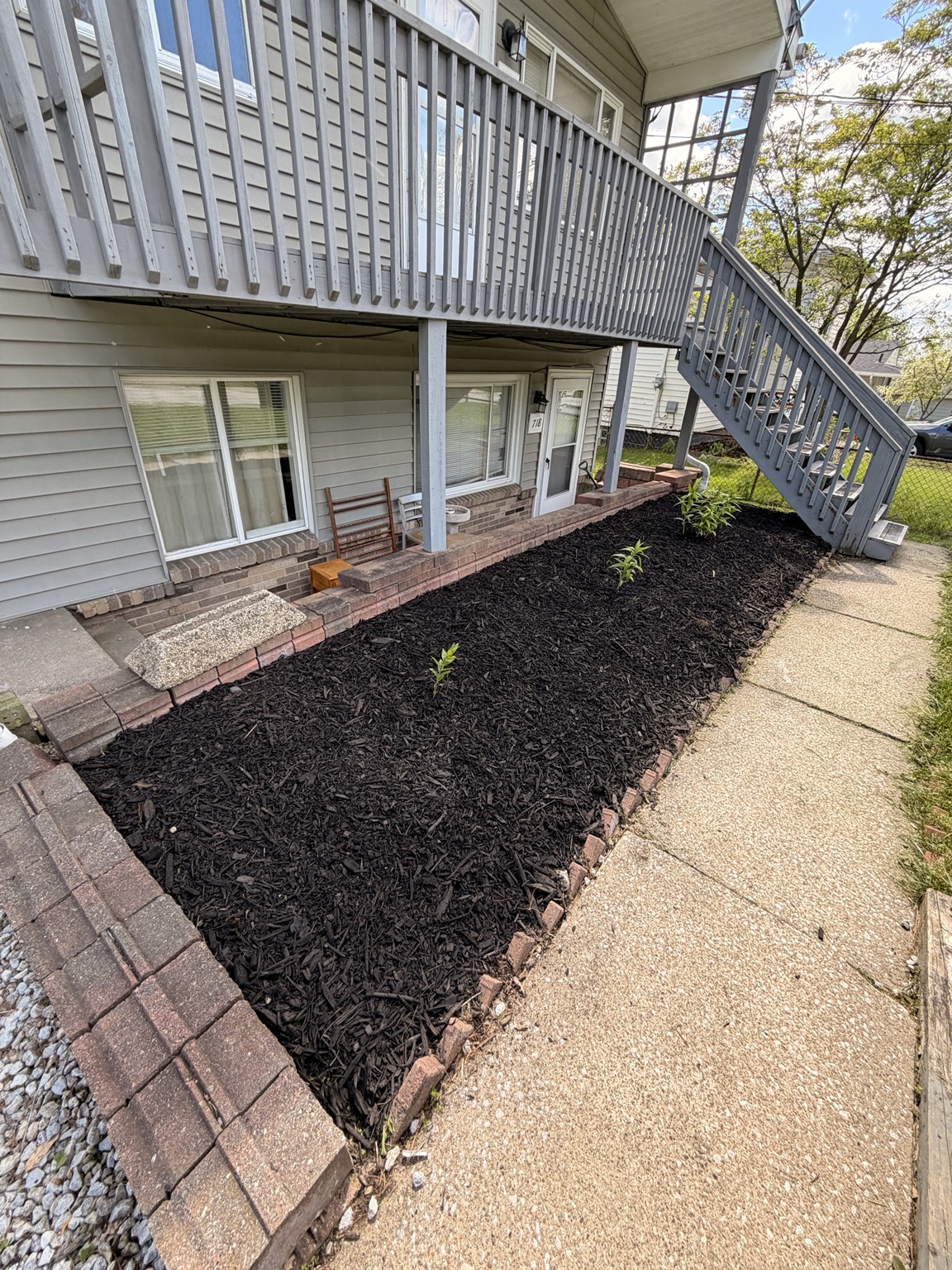 After: clean mulch bed and fresh plants installed