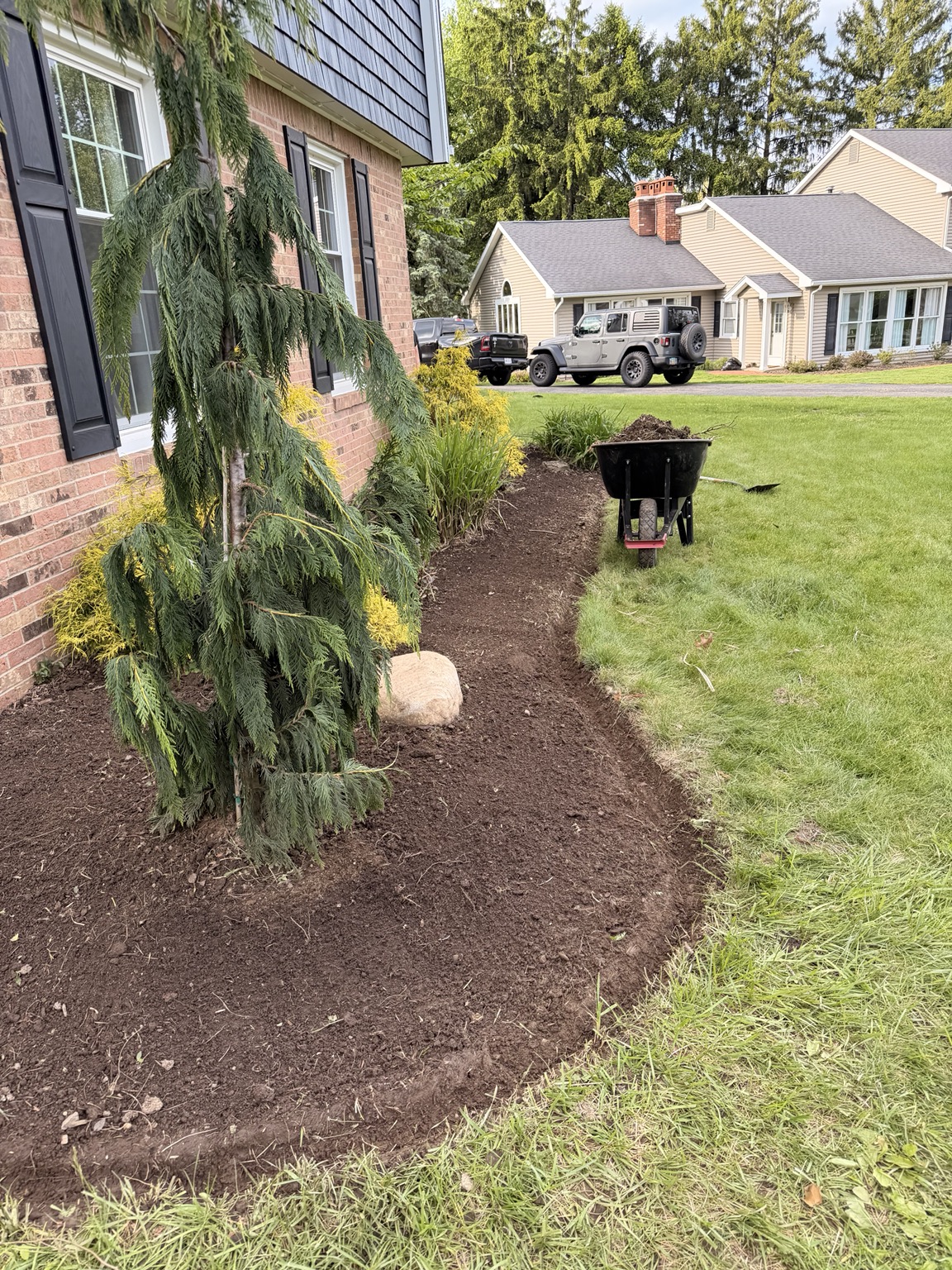 Fresh mulch installation in progress Canton OH landscaping
